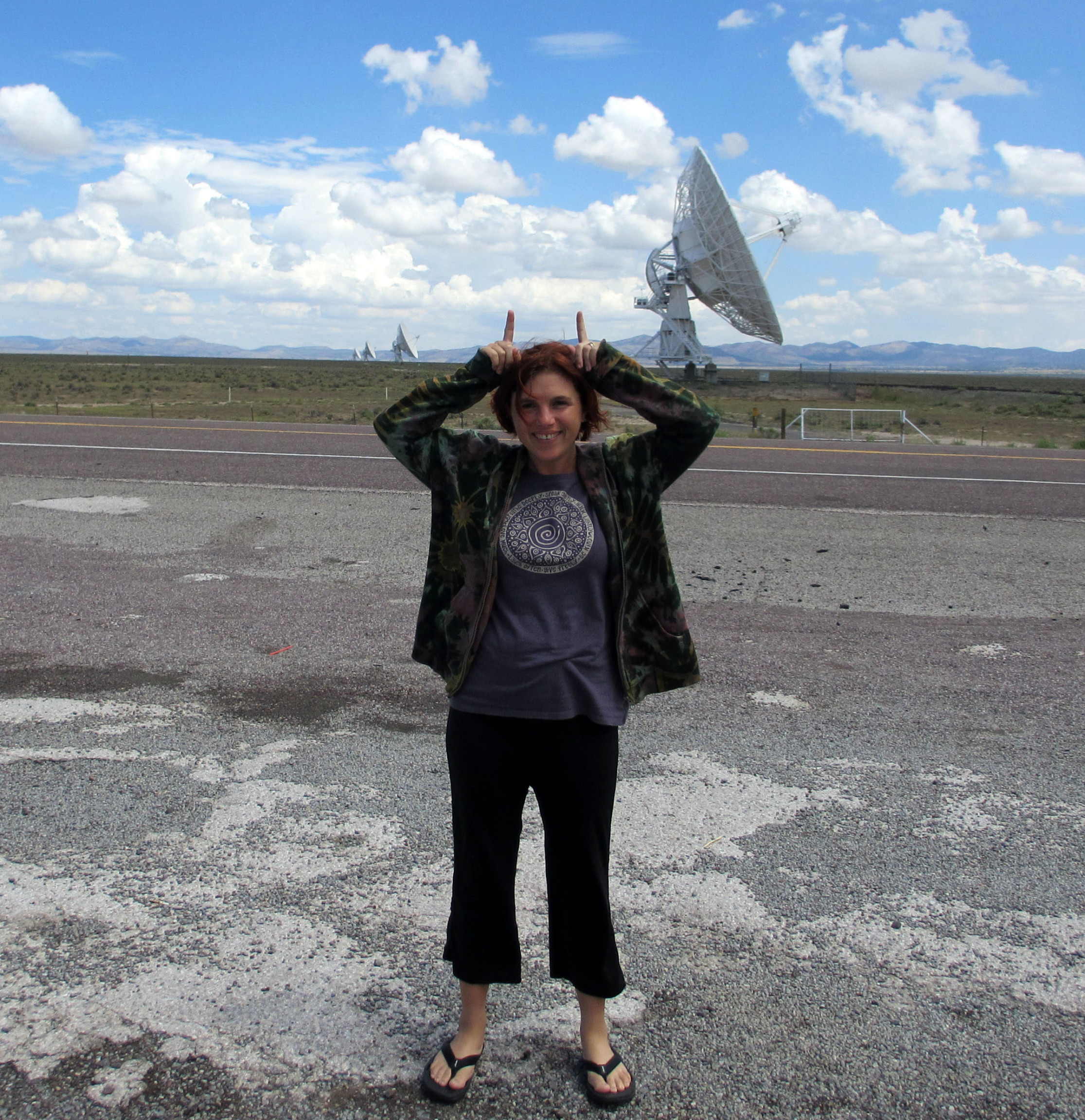 Me in New Mexico on a road with antennas in the background.