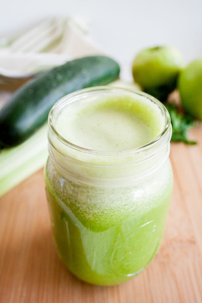 Green Juice Detox Recipe with ingredients in the background.