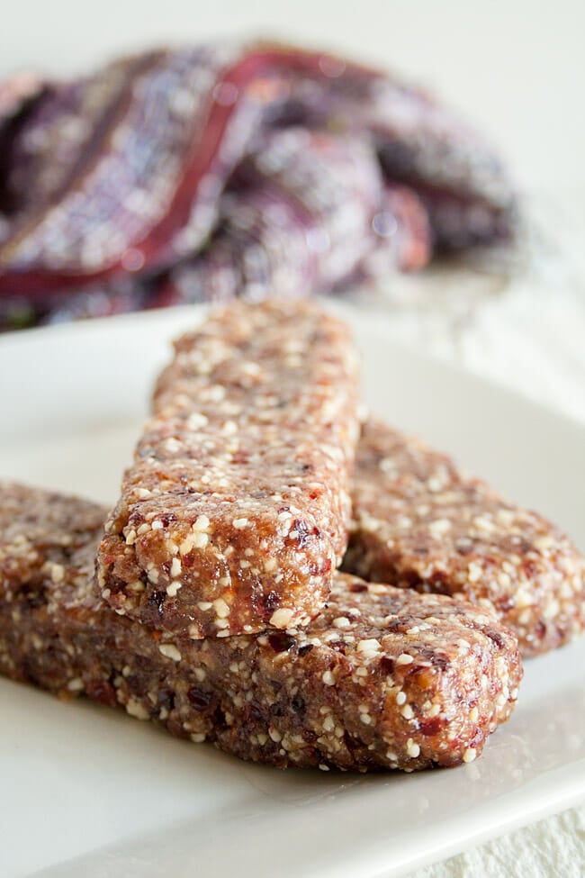 Cashew Cranberry Bars on a white plate. They are one of the vegan travel snacks to pack on your next trip.