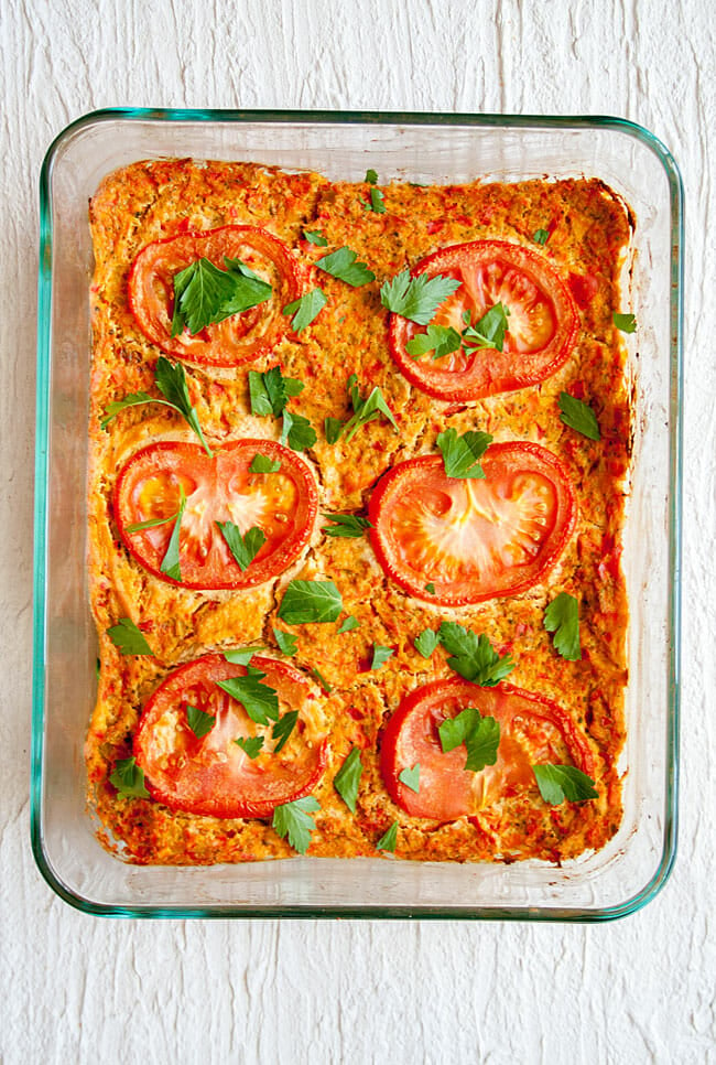 Tofu Frittata with tomato slices on top in baking dish.