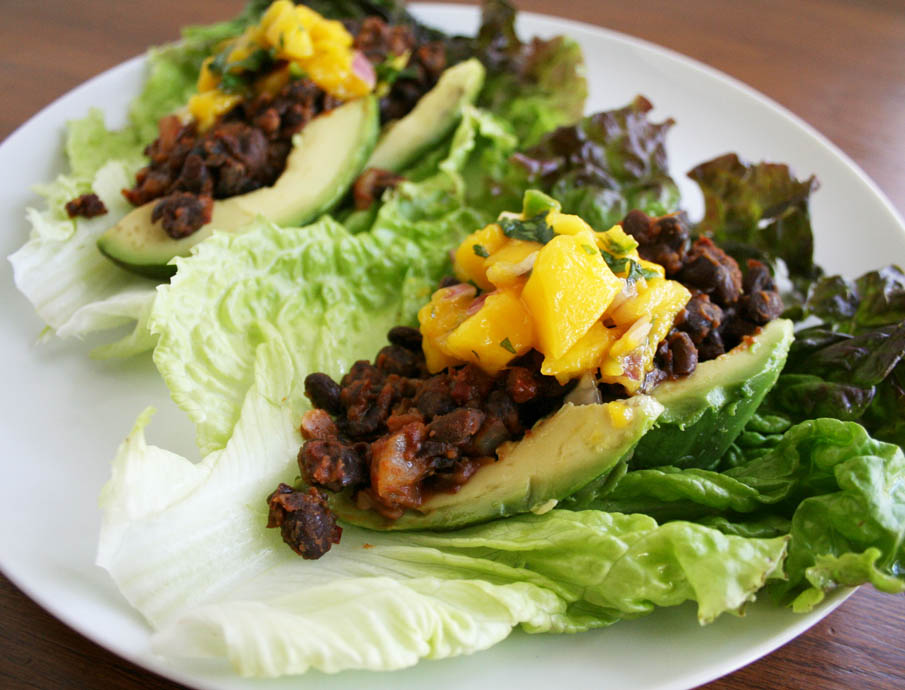 Maple Chipotle Black Bean Lettuce Wraps with Mango Salsa on a white plate.