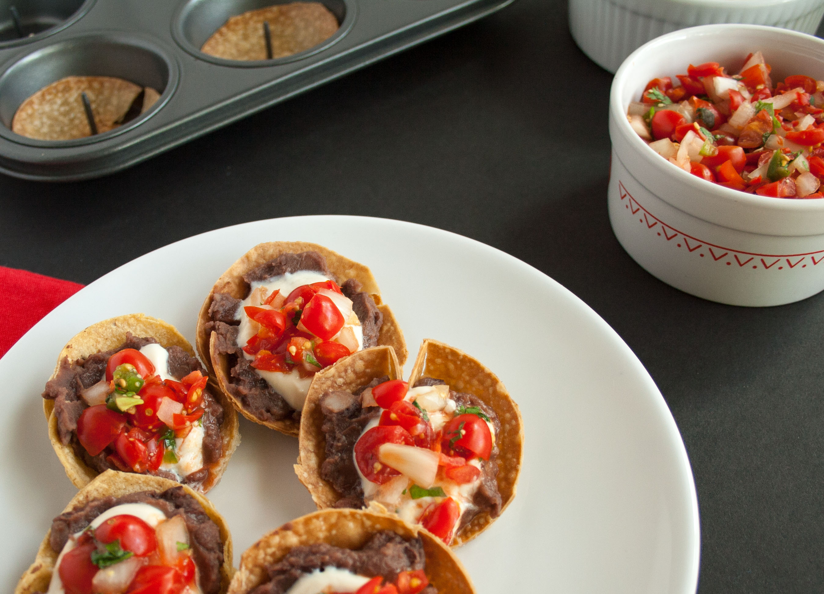 Mini Bean Tostadas with Pico de Gallo and Vegan Sour Cream. 