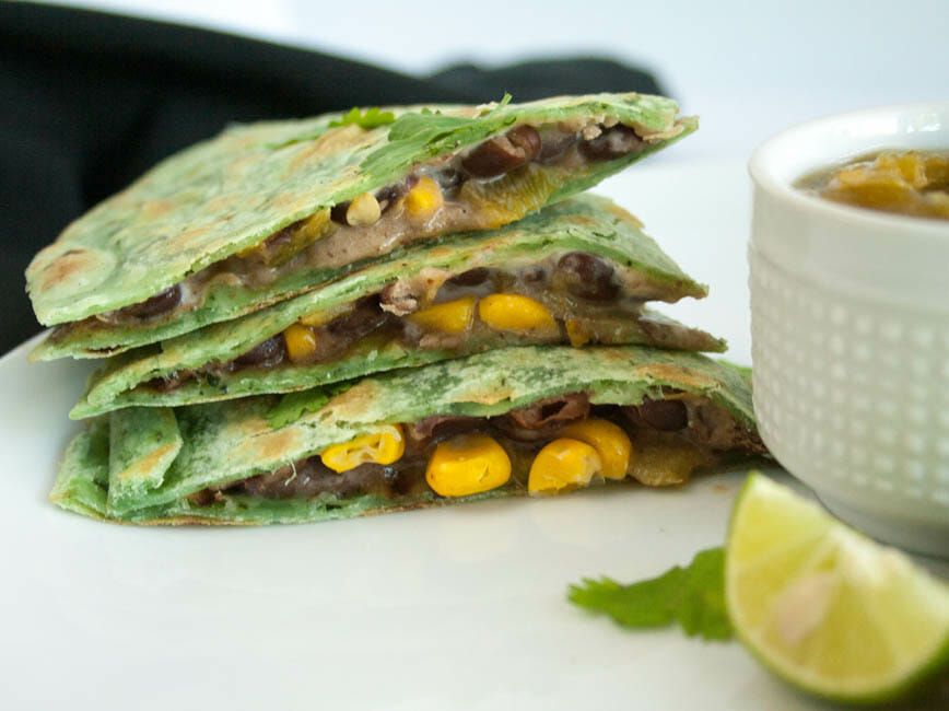 Black Bean and Corn Vegan Quesadilla stacked on plate.