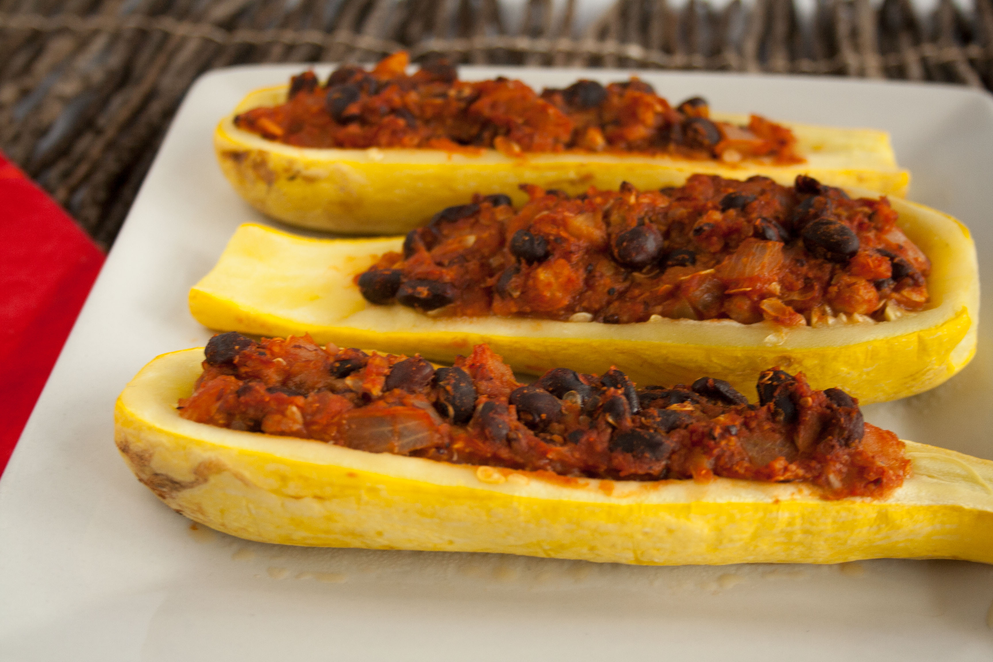 Stuffed Summer Squash Boats on a plate close up.