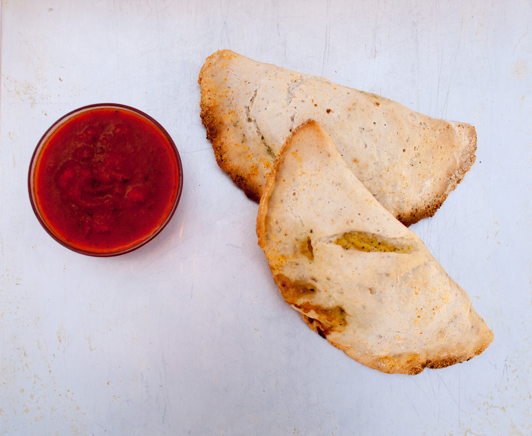 Spinach and Tofu Ricotta Calzones birds eye view of two calzones.