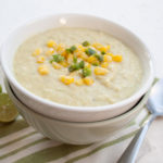 Creamy Corn Soup with Jalapeño in a bowl with spoons.