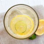 Homemade Lemon Lime Soda in a glass with lime and lemon.