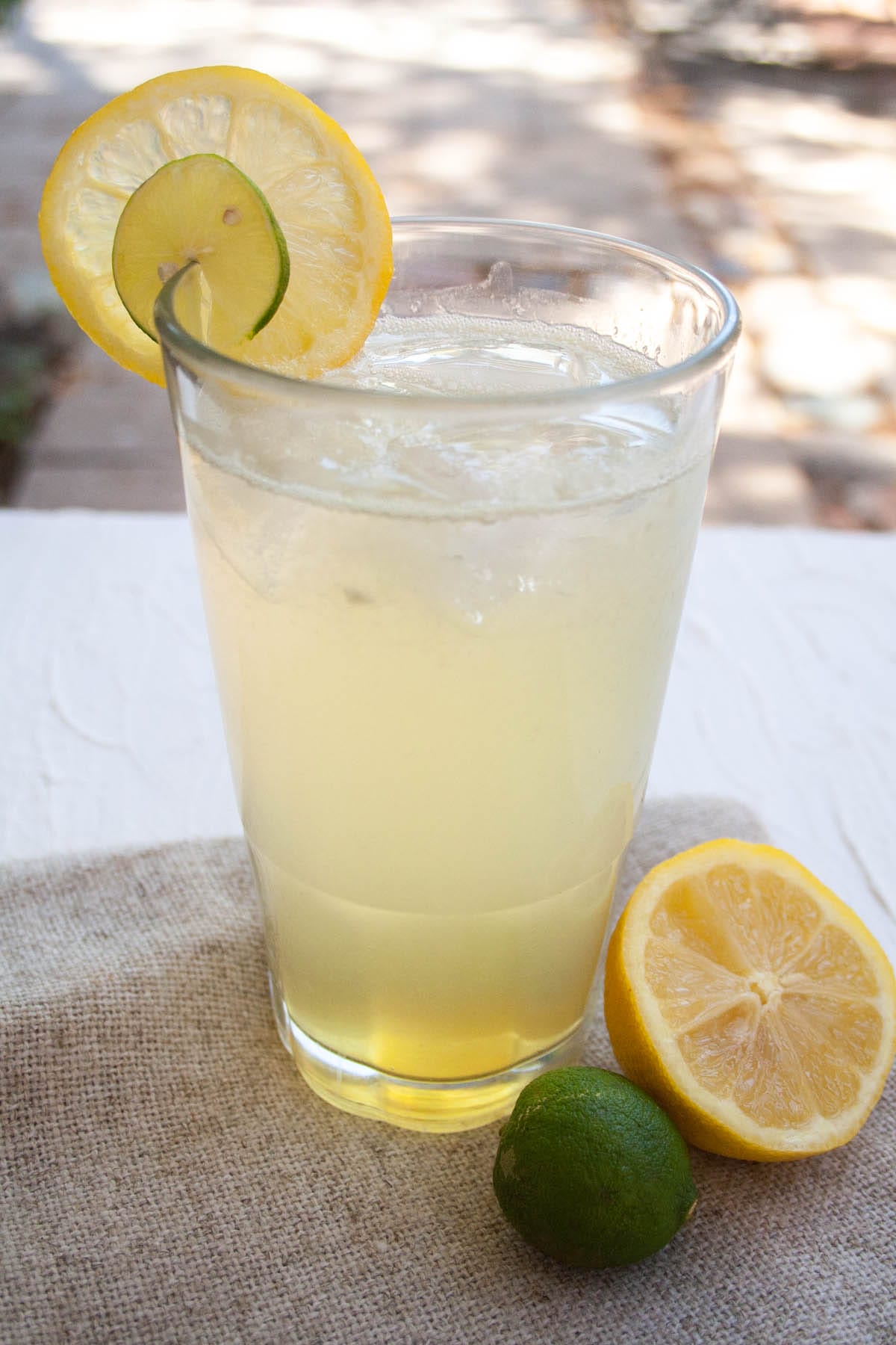 Homemade Lemon Lime Soda in a glass with lime and  lemon slices.