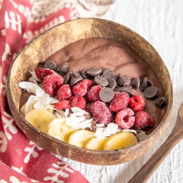 Chocolate Acai Bowl in wood bowl with spoon.