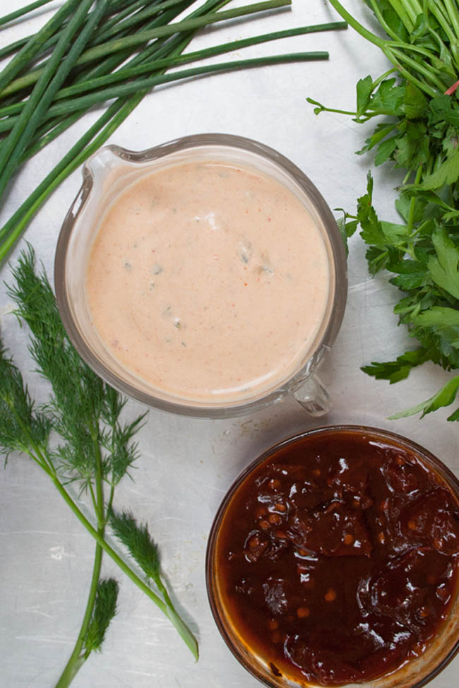 Vegan Chipotle Ranch Dressing birds eye view with bowl of chipotle peppers and herbs.