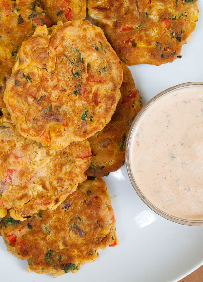 Vegan Vegetable Fritters vertical birds eye view with vegan chipotle ranch dressing.