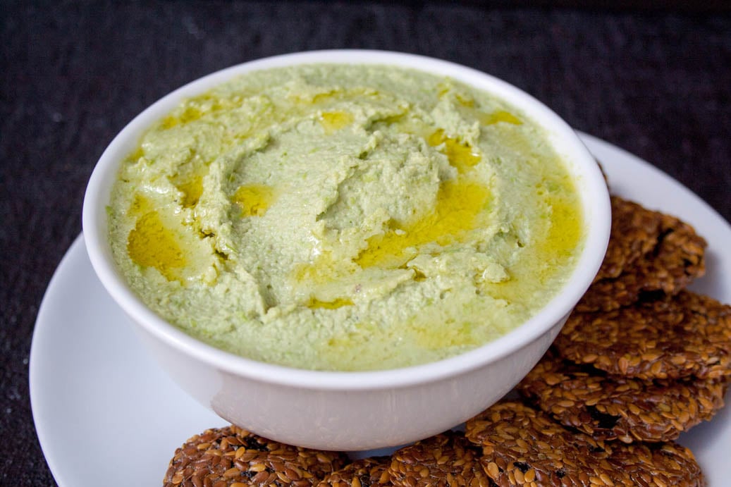 Edamame Avocado Hummus in a bowl with crackers.