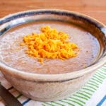 3 Ingredient Refried Bean Soup in a bowl with a spoon.