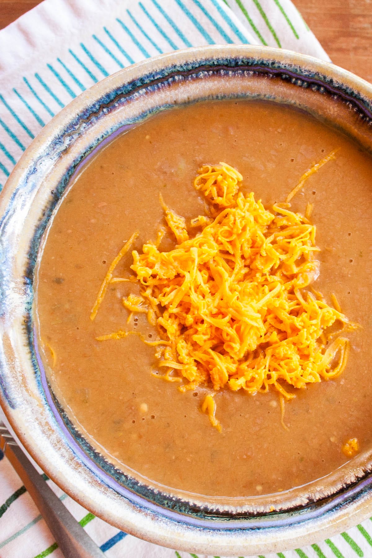 3 Ingredient Refried Bean Soup in a bowl with a spoon.