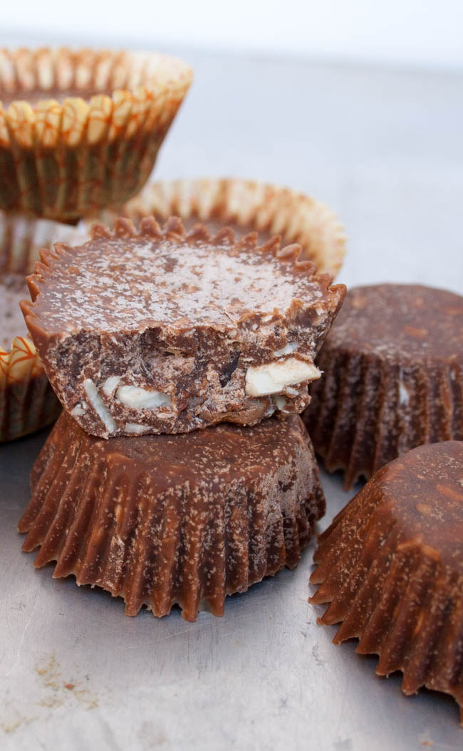 Keto Chocolate Coconut Fat Bombs close up. One fat bomb has a bite taken out of it.