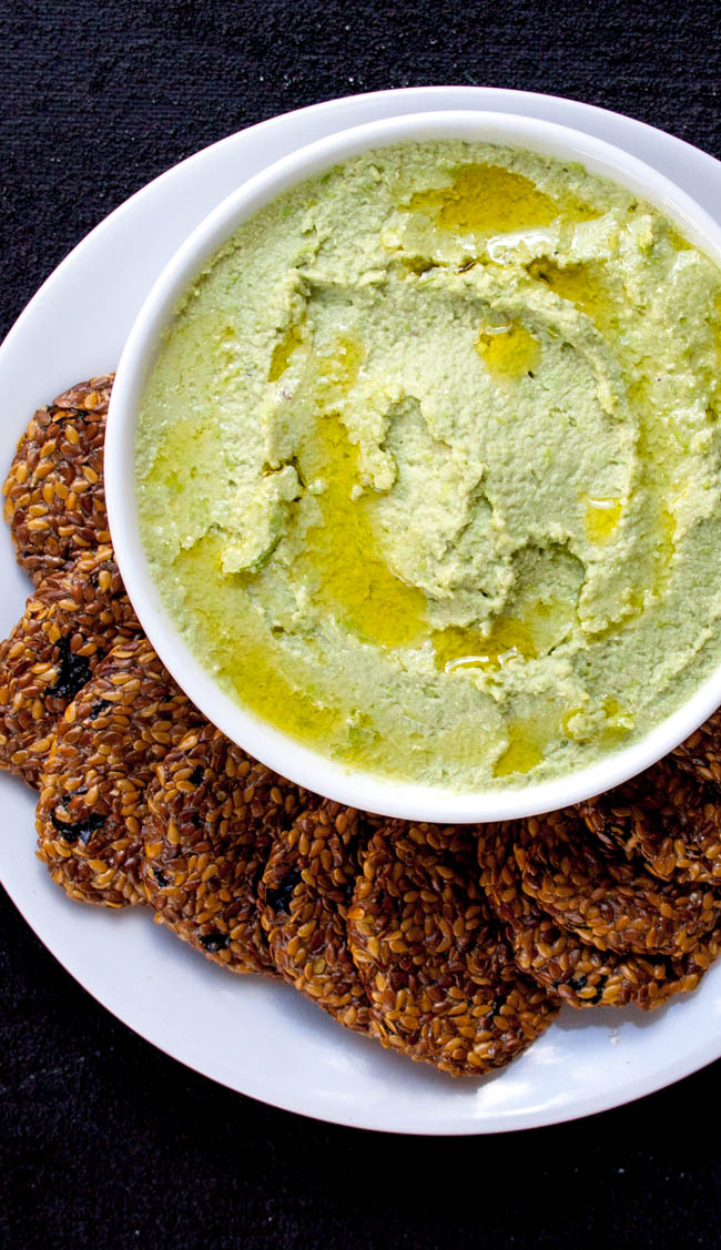 Edamame Avocado Hummus on plate with crackers.