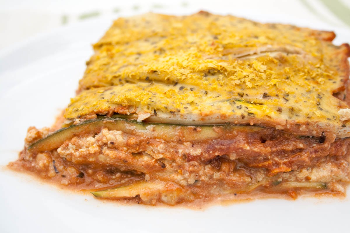 Vegan Zucchini Lasagna with Tofu Ricotta and Walnut Sauce (gluten free) - This recipe is indulging, yet guilt-free! It is low carb, healthy, and satisfying! Vegan Zucchini Lasagna on a plate.