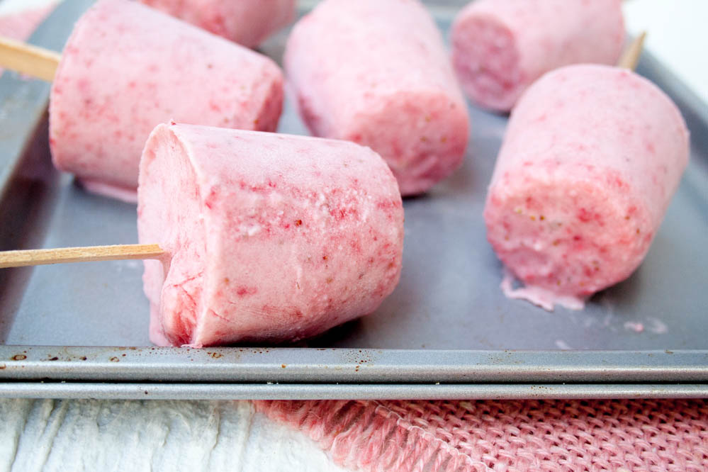 Vegan Strawberries and Cream Popsicles close up.