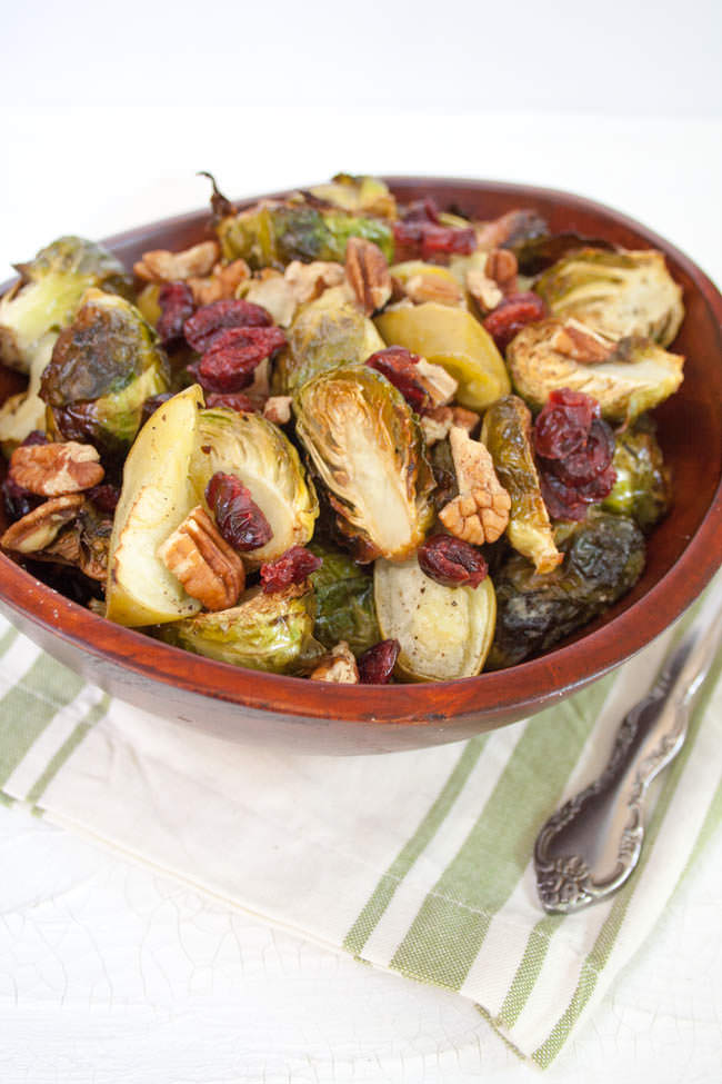 Roasted Brussels Sprouts and Apples with Tahini Dressing in wood bowl.