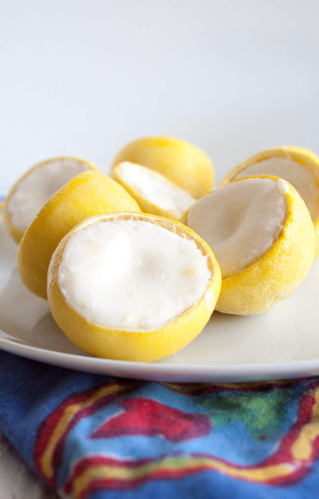 Lemon Coconut Fat Bombs in lemon peels on plate. 