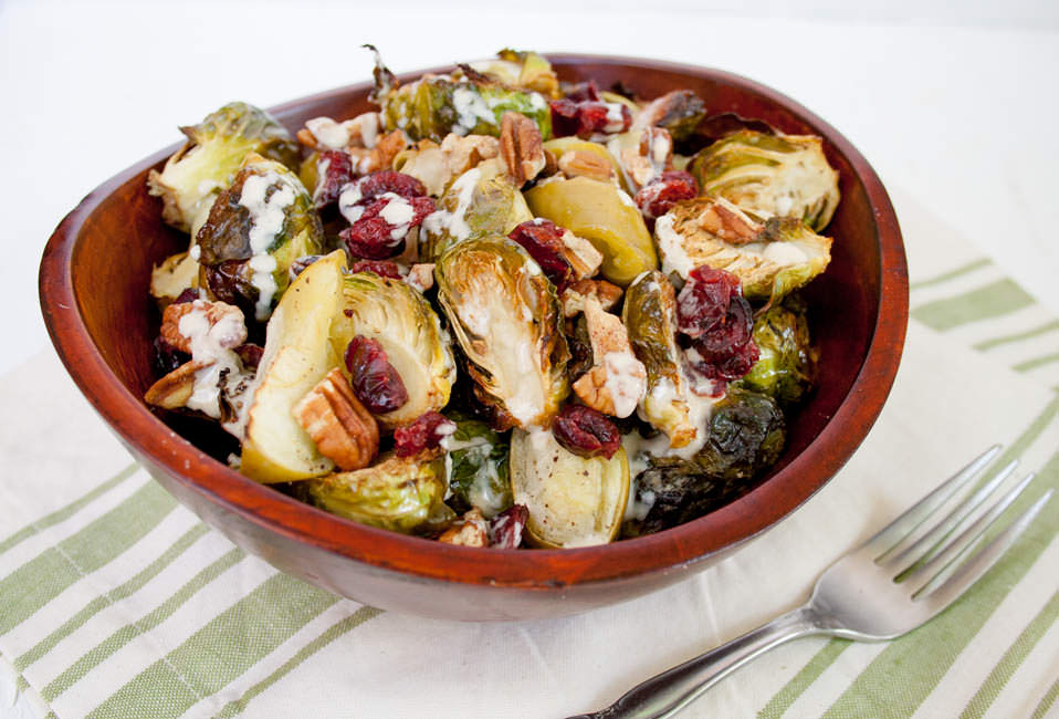 Roasted Brussels Sprouts and Apples with Tahini Dressing in a bowl.