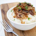 Vegan Mashed Cauliflower with Caramelized Onions and Mushrooms with a fork.