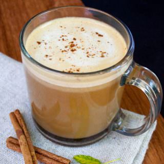 Vegan Pumpkin Spice Latte with cinnamon sticks.