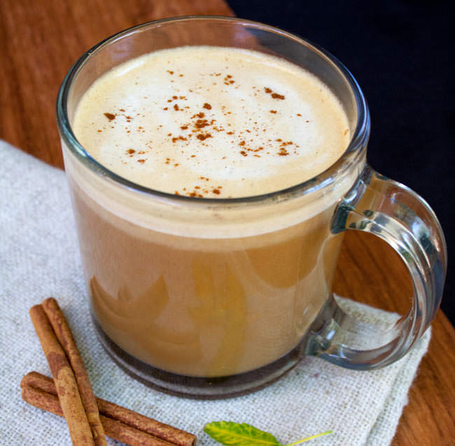 Vegan Pumpkin Spice Latte with cinnamon sticks.