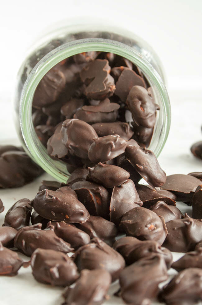 Vegan Mexican Chocolate Covered Almonds spilling out of jar.