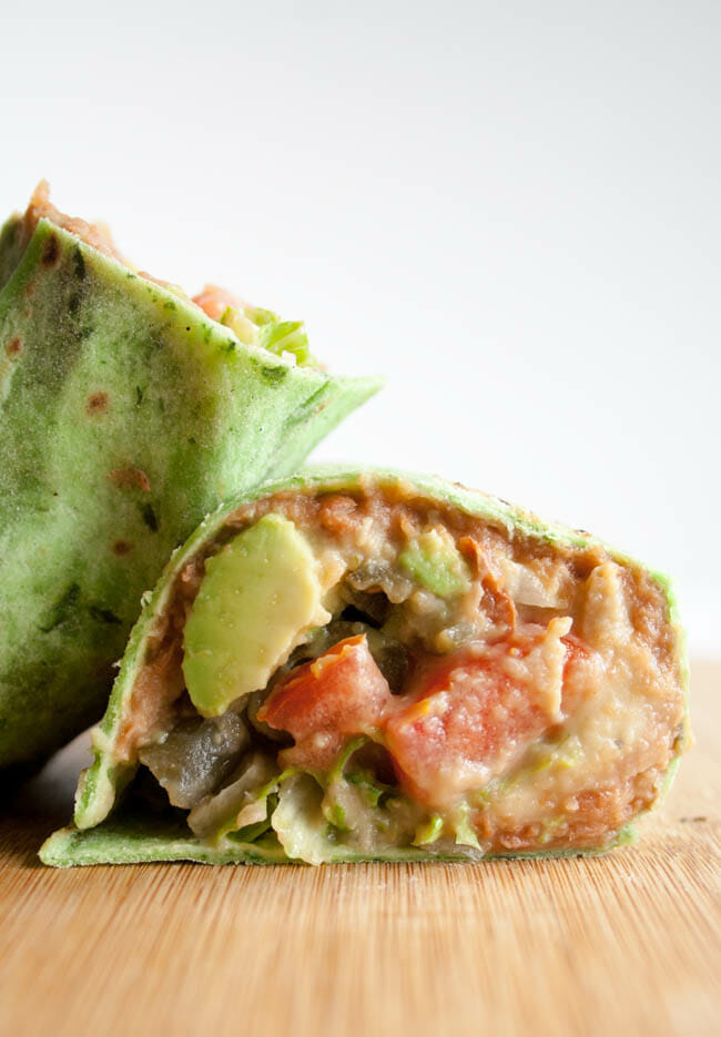 Vegan Refried Bean Burrito stacked on a cutting board.