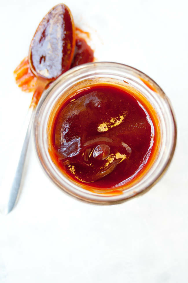 4 Ingredient Sriracha BBQ Sauce in a mason jar with spoon.