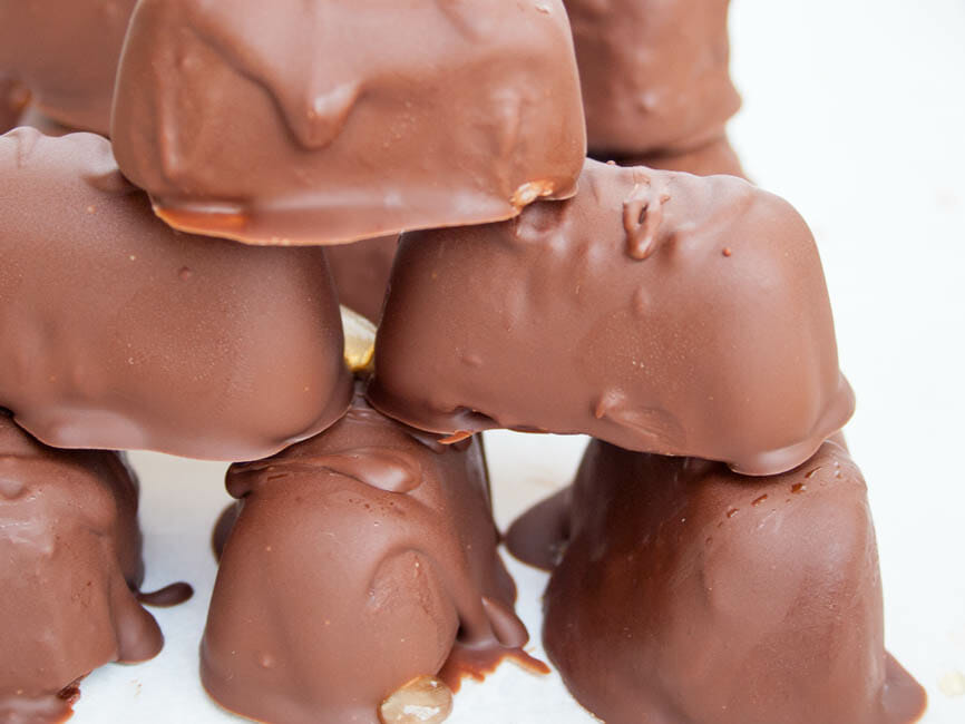 Chocolate Covered Peanut Butter Frozen Yogurt Bites stacked on top of each other.