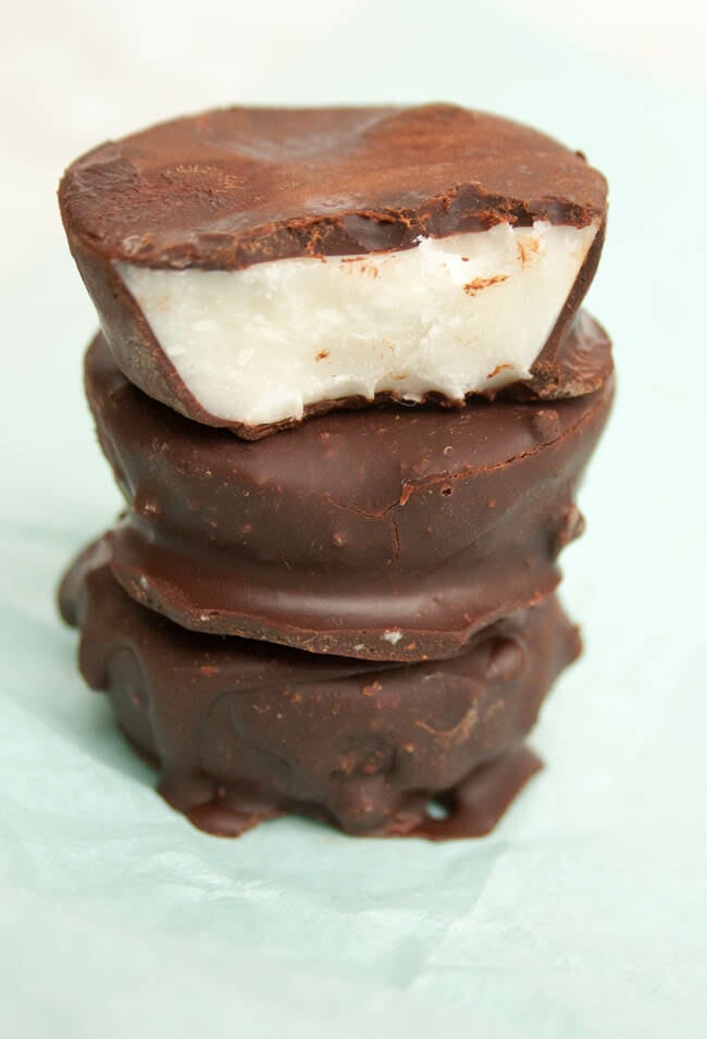 Sugar Free Peppermint Patties stacked with one with a bite out of it.