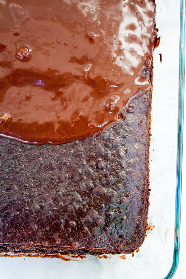 Chocolate cake with frosting on ¾ of the cake.