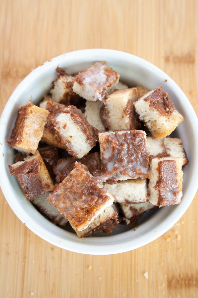Cubes of bread with chocolate peanut mixture in a ramekin.