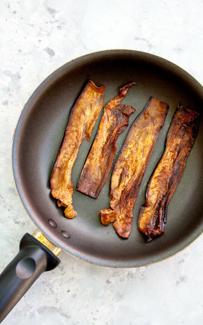 Eggplant Bacon in pan after being fried.
