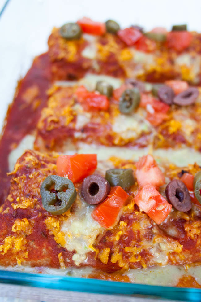 Smothered Vegan Burritos close up in baking dish.