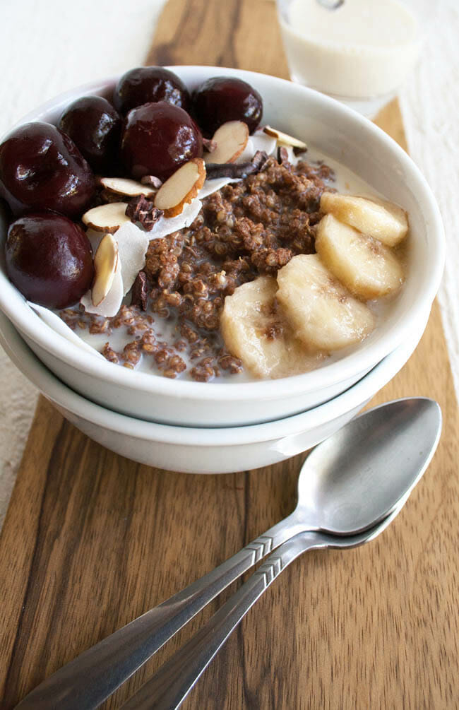 Chocolate Quinoa Breakfast Bowl with almond milk in the background.