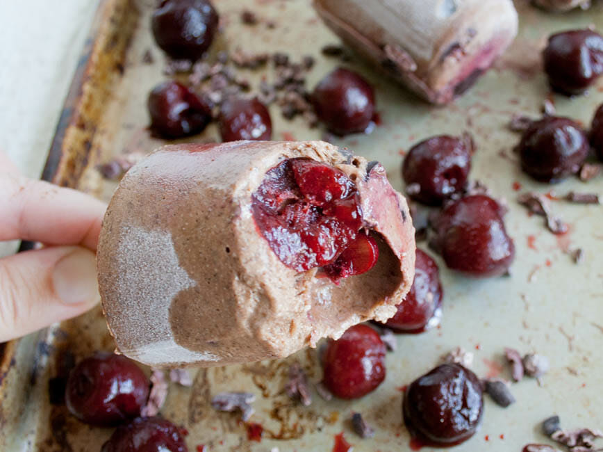Chocolate Cherry Chia Pudding Popsicle with bite out of it.