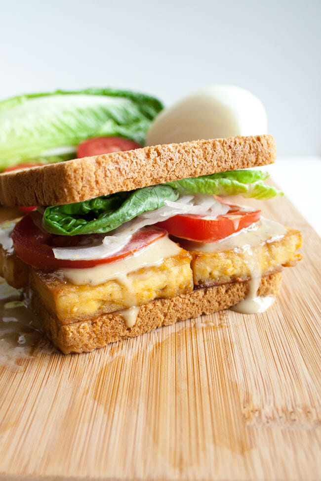 Maple Dijon Baked Tofu Sandwich on a cutting board.