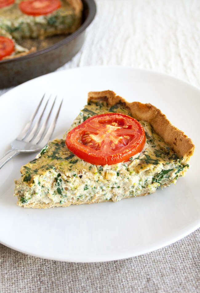 Spinach and Broccoli Vegan Quiche on a plate with fork.