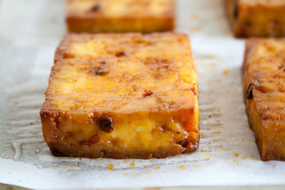 Maple Chipotle Baked Tofu on parchment paper.