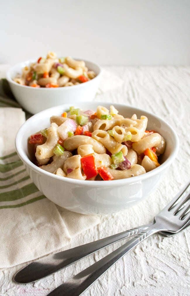Vegan Macaroni Salad in two bowls with forks.