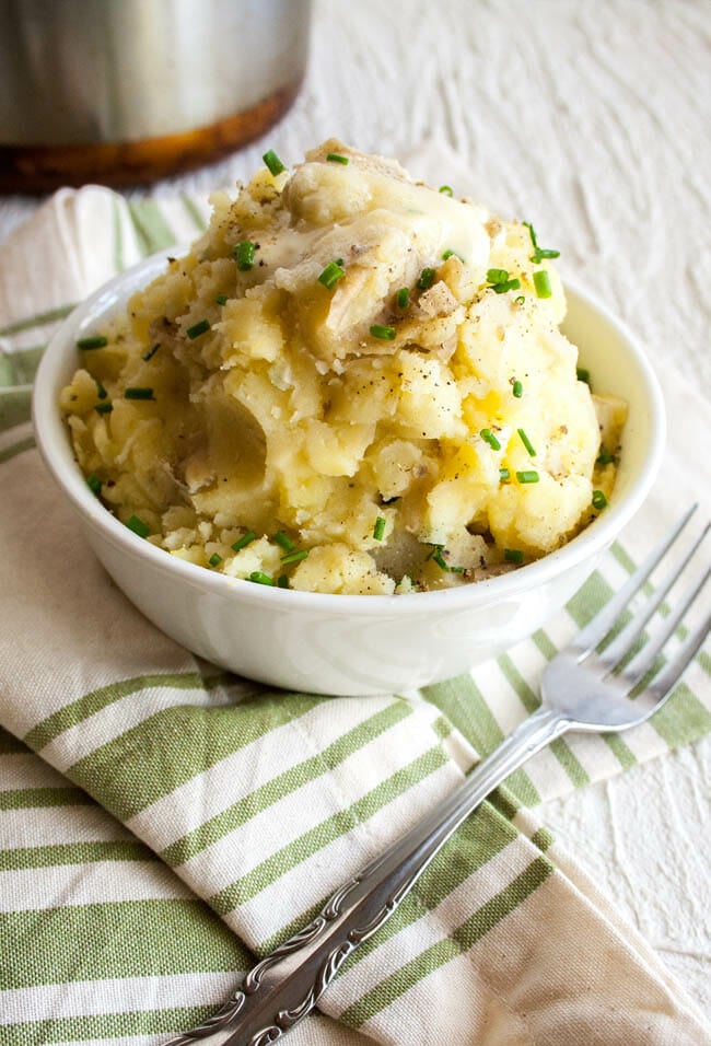 Vegan Mashed Potatoes with Roasted Garlic in a bowl with fork.
