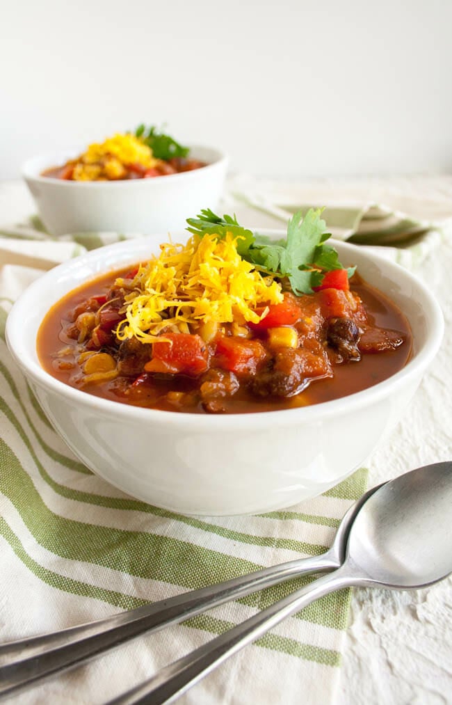 Black Bean and Corn Chili in two bowls with spoons.