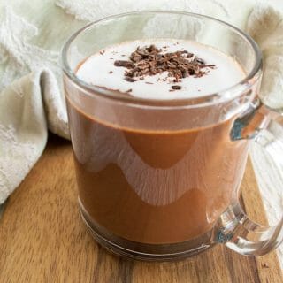 Mint Hot Chocolate in a mug on a cutting board.