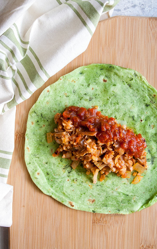 Burrito open faced with Jackfruit and Cauliflower Rice and salsa. 