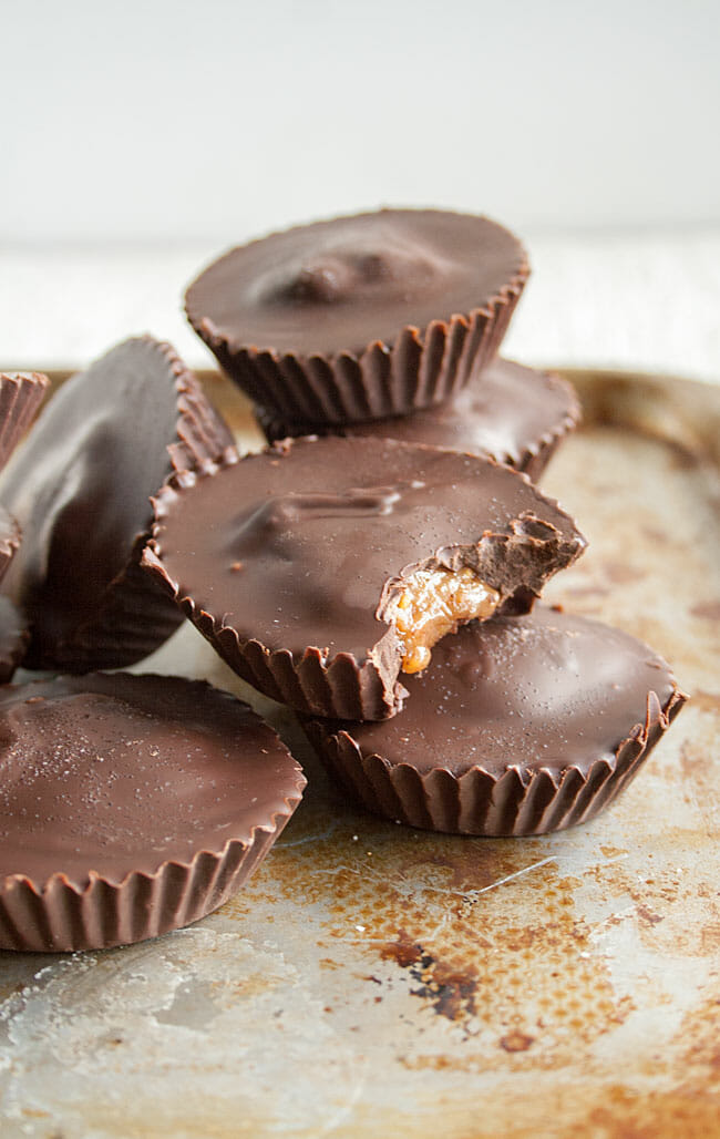 Creamy Almond Butter Cups stacked on a sheet pan.