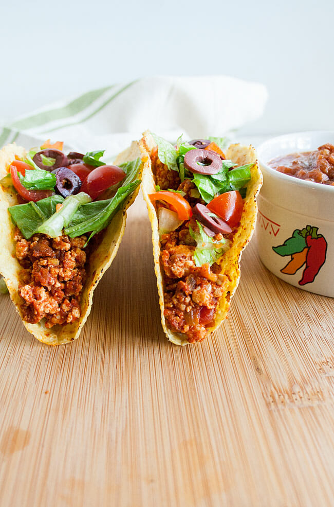 Spicy Tofu Tacos on a cutting board with salsa.