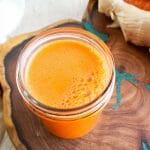 Carrot Ginger Juice on a cutting board.